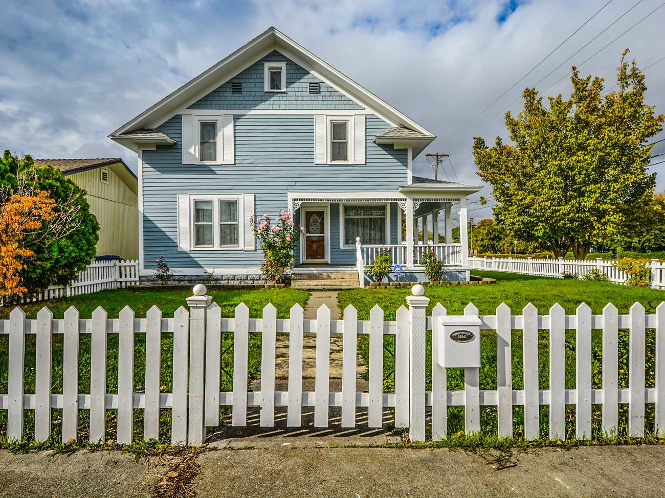 Home behind a freshly built white picket fence